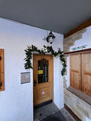 a door with a christmas wreath on it at Sellaronda - Ciampac Experience in Alba di Canazei
