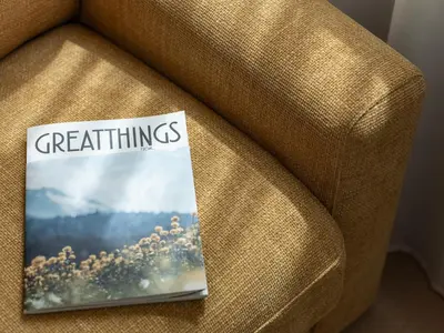 a book sitting on a couch with the words parenting at Dianthus Apartment in Lana