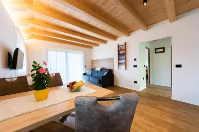 a living room with a table and a blue couch at Lüch de Corona in Frena