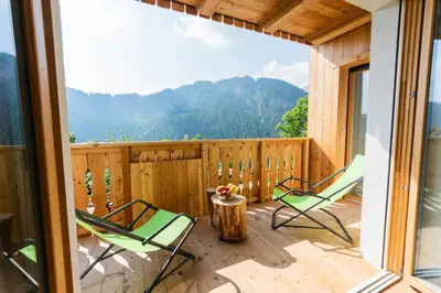 a balcony with chairs and a view of mountains at Lüch de Corona in Frena