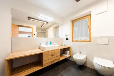 a bathroom with a sink and a toilet at Lüch de Corona in Frena