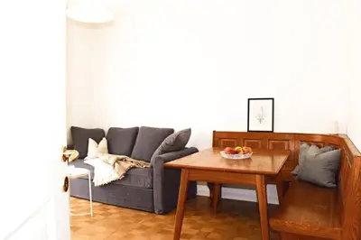 a living room with a couch and a table at Elina Apartment in Merano