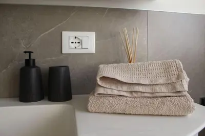 a pile of towels sitting on top of a bathroom counter at Elina Apartment in Merano