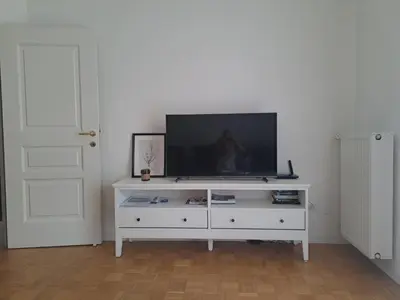 a white entertainment center with a flat screen tv on it at Elina Apartment in Merano