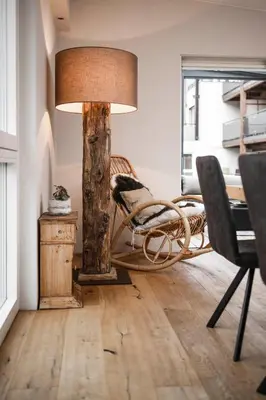 a room with a lamp and a chair and a table at Dolomites Alpin Penthouse, 90qm, privat Sauna - privat Whirlpool in Mühlbach