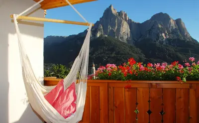 a hammock with a view of a mountain at Singerhof in Castelrotto
