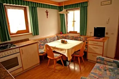a bedroom with two twin beds and a window at Appartamenti Loega in San Cassiano