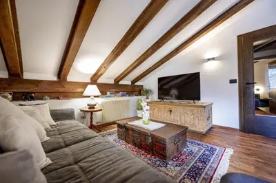 a small kitchen with red cabinets and a table at Apartments Raphael in Ortisei