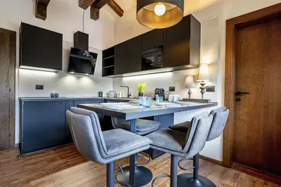 a living room with a couch and a tv at Apartments Raphael in Ortisei