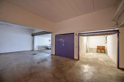 an empty room with a garage with a purple door at Apartments Elmarino in Ortisei