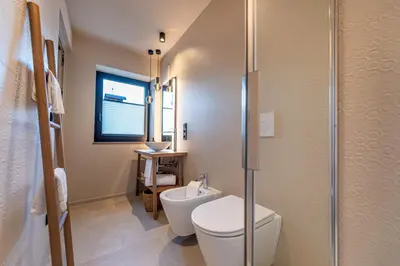 a bathroom with a toilet and a glass shower at Apartments Am Platzl Living in Laion