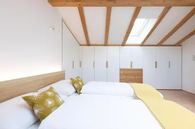 a bedroom with two white beds and a skylight at Charmantes Ferienhaus in Eppan, Südtirol, ganzes Haus nahe Montiggler Badeseen und Bozen in Appiano sulla Strada del Vino