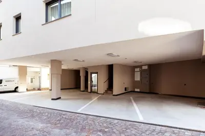 an empty parking lot in front of a building at Ramoser Living Apartments in San Martino