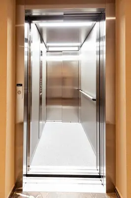 an elevator in a hotel room with the door open at Ramoser Living Apartments in San Martino