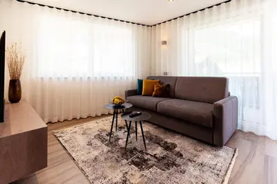 a living room with a couch and a table at Ramoser Living Apartments in San Martino