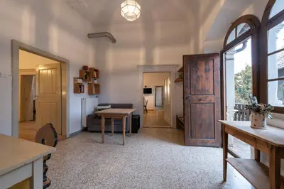 a living room with a door and a table at der Paterhof- wohnen in historischen Mauern in Pianizza di Sopra
