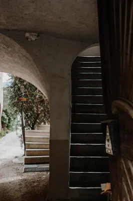 a stairway leading to a building with a spiral staircase at der Paterhof- wohnen in historischen Mauern in Pianizza di Sopra
