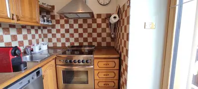 a kitchen with a stove and a sink at Ai Grisi in Cavalese