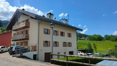 a white building with a lot of windows at Ai Grisi in Cavalese
