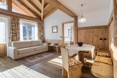 a living room with a couch and a table at Cësa Marmolada 1318 in Ortisei