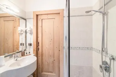 a bathroom with a sink and a shower at Cësa Marmolada 1318 in Ortisei