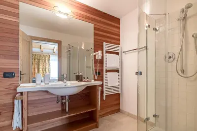 a bathroom with a sink and a shower at Cësa Marmolada 1318 in Ortisei