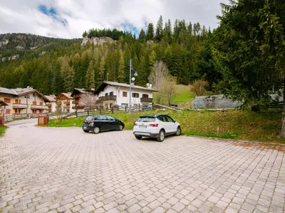two cars are parked in a parking lot at Apartment Appartamento Crepaz by Interhome in Canazei