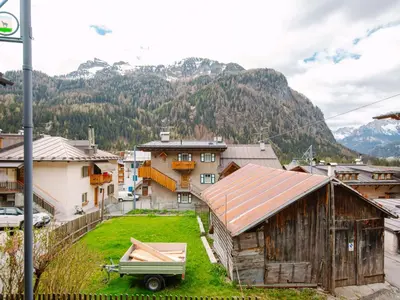 a village with houses and mountains in the background at Apartment Appartamento Crepaz by Interhome in Canazei