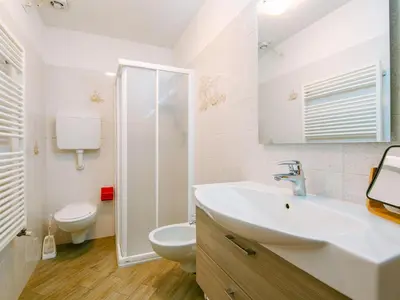 a bathroom with a sink and a toilet and a shower at Apartment Appartamento Crepaz by Interhome in Canazei
