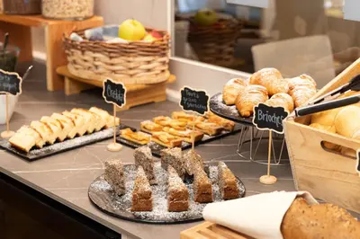 a buffet line with many different types of food at Hotel Panorama in San Martino di Castrozza