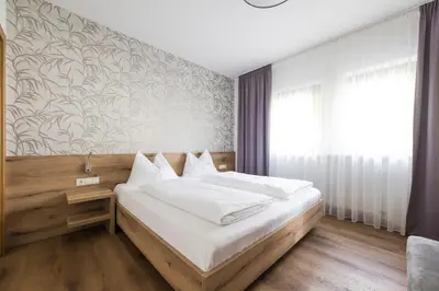 a bedroom with a bed and a wall mural at Ferienwohnungen Alber in Rablà