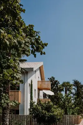 a white house with wooden balconies and a fence at die Waltraud im Refugium Rochus in Pianizza di Sopra
