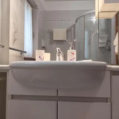 a white sink in a bathroom with a mirror at Casa San Valentino Dolomiti Val di Zoldo in Val di Zoldo
