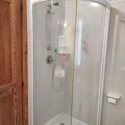 a shower with a glass door in a bathroom at Casa San Valentino Dolomiti Val di Zoldo in Val di Zoldo