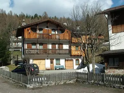 a large house with a balcony on top of it at Casa San Valentino Dolomiti Val di Zoldo in Val di Zoldo