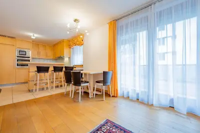 a kitchen and dining room with a table and chairs at Cesa Delba in Canazei