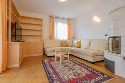 a living room with a couch and a table at Cesa Delba in Canazei