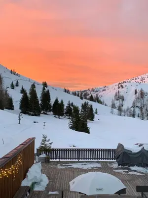 a view of a snow covered mountain with an umbrella at Darling Home in Merano