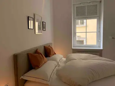 a bedroom with two beds and a window at Darling Home in Merano