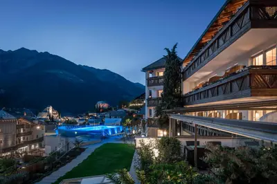 a view of a resort at night at Hotel Sunnwies in Schenna