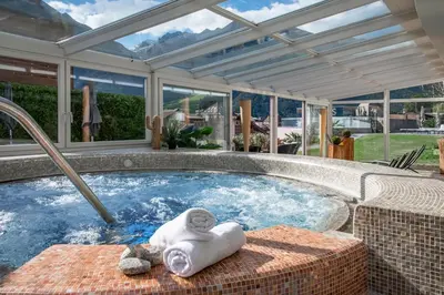 a jacuzzi tub in a house with a conservatory at Hotel Sunnwies in Schenna