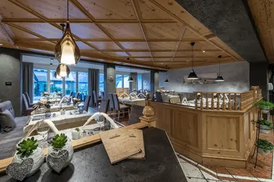 a dining room with a table and some chairs at Hotel Sunnwies in Schenna