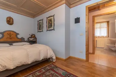 a bedroom with a bed and a wooden ceiling at Casa Soreje in Mazzin