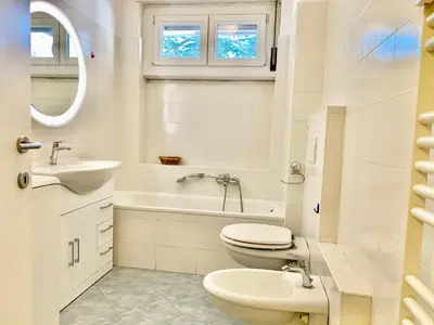a white bathroom with a toilet and a sink at Appartamento Bolzano - Vittorio Veneto - Parcheggio incluso in Bolzano