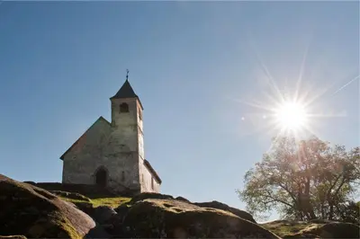 an old church sitting on top of a hill at Residence Rebgut in Tesimo
