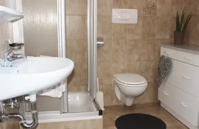 a bathroom with a sink and a toilet and a shower at Residence Rebgut in Tesimo
