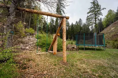 a swing set and a bench in a field at Chalet alla Perla, Grumes in Grumes