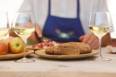 two glasses of white wine and a plate of bread and apples at Botenhof - Urlaub auf dem Bauernhof - Agriturismo in Sarntal