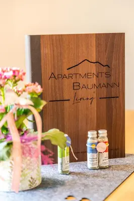 a sign for ananthemums binnantulum inventory next to flowers and jars at Apartments Baumann Living in Rodengo