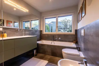 a bathroom with a tub and a toilet and a sink at Mali Apartments Garden Suite in Tirolo